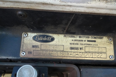 Peterbilt metal identification plate on cab showing Peterbilt Motors Company, Newark, California USA; model L349? or L-?; VIN 1XP9LB0X0GN201822; chasis wt 11200 lbs; plate text visible.
