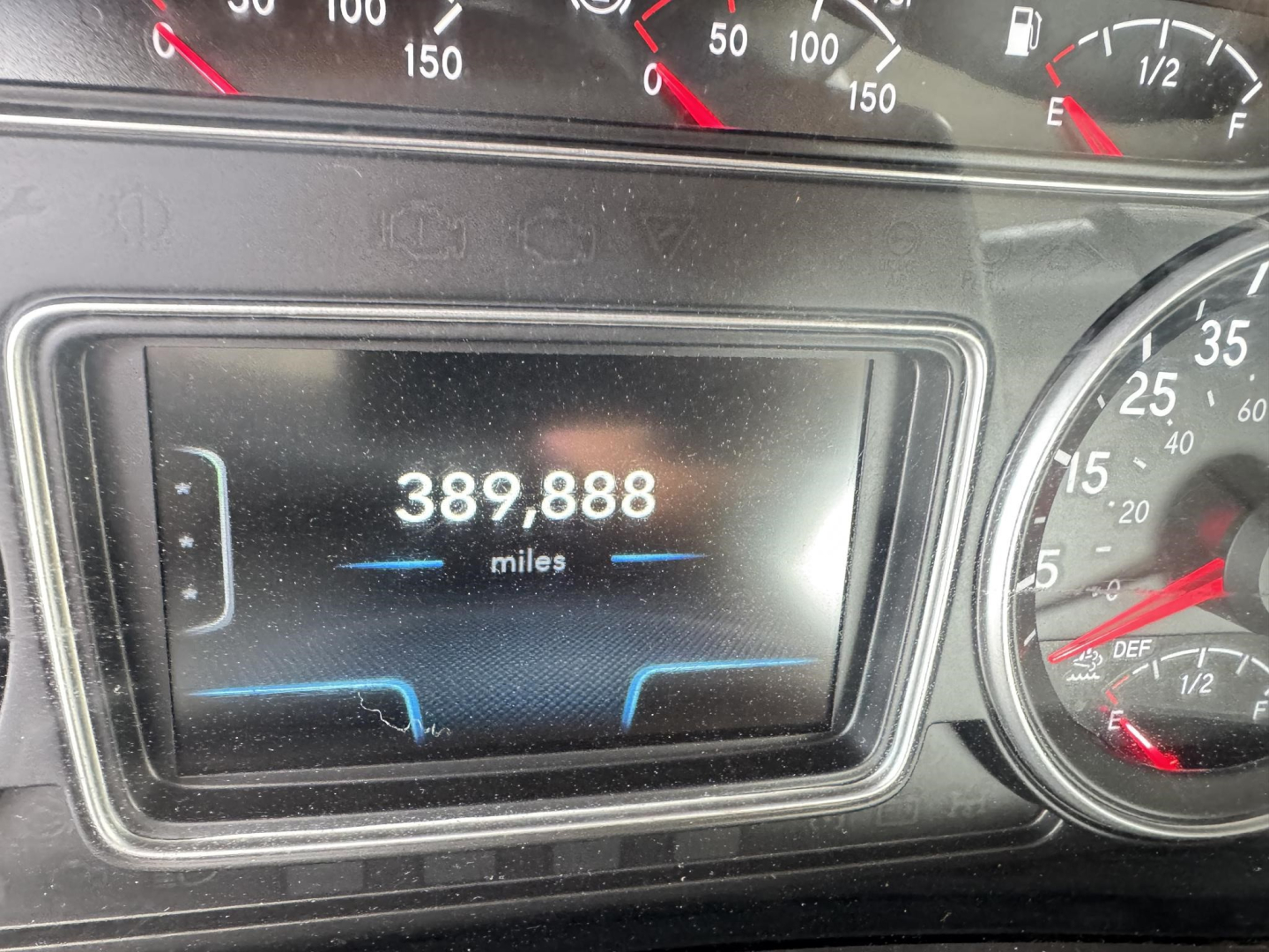 Dashboard display showing 389,888 miles on the odometer; gauge cluster with speedometer and other dials visible.