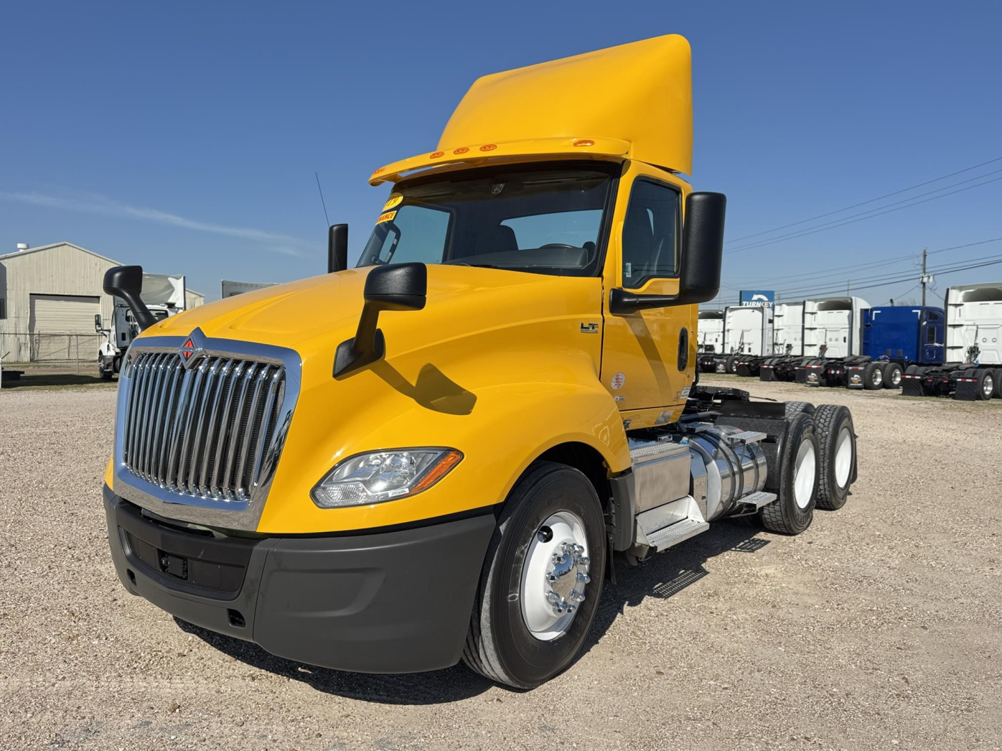 Truck image: 2019 International LT daycab tractor in yellow, front-left view, with fuel tanks and dual rear axles visible.