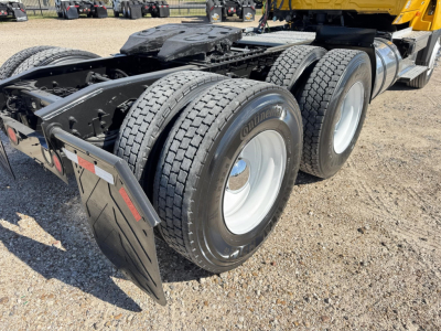 Triple-axle tractor rear showing dual rear tires with Continental tires and fender mud flaps.