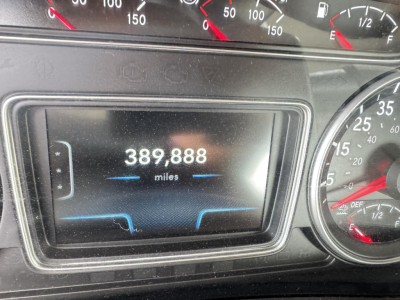 Dashboard display showing 389,888 miles on the odometer; gauge cluster with speedometer and other dials visible.