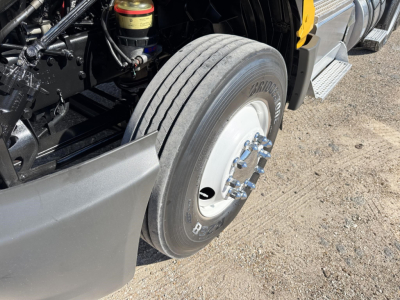 Front wheel and brake area of a 2019 International LT conventional daycab, showing tire, wheel hub, and suspension components.