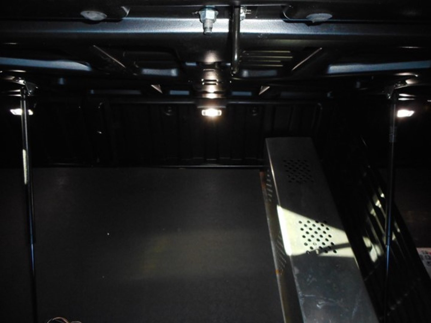 Freightliner Cascadia truck interior indicating under dashboard with metal framework and wiring visible.