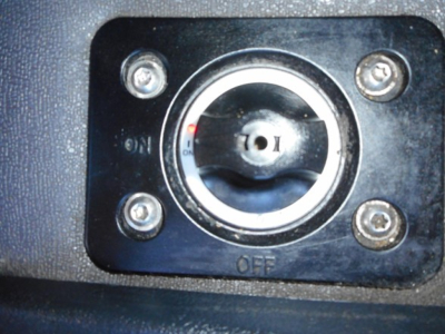 Dial/lock switch in black panel with circular knob, four screws around, 'OFF' text at bottom, small red indicator line near 'ON' label