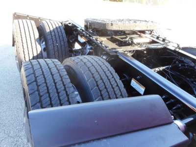 Freightliner Cascadia chassis showing dual rear axles and frame rails with tires and suspension components.