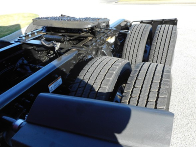 Freightliner Cascadia 126 chassis rear view showing twin rear axles and suspension components with tires and frame.