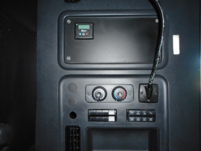 Cab interior panel of a Freightliner Cascadia showing control switches and venting area.