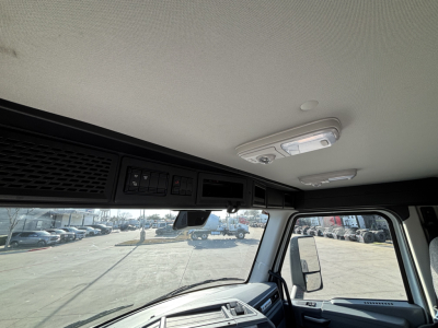Cab interior ceiling of a Mack AN64T with overhead console and dome light.