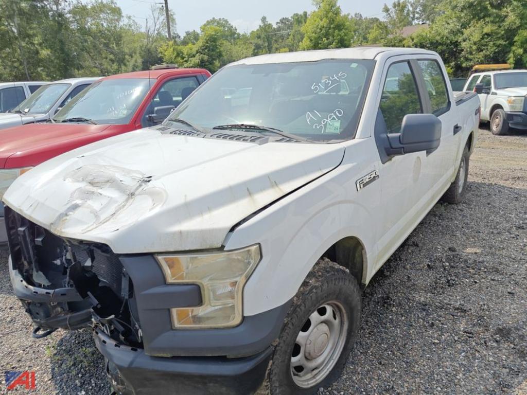 White Ford F-150 pickup truck with front-end damage and missing grille showing headlight and bumper area.