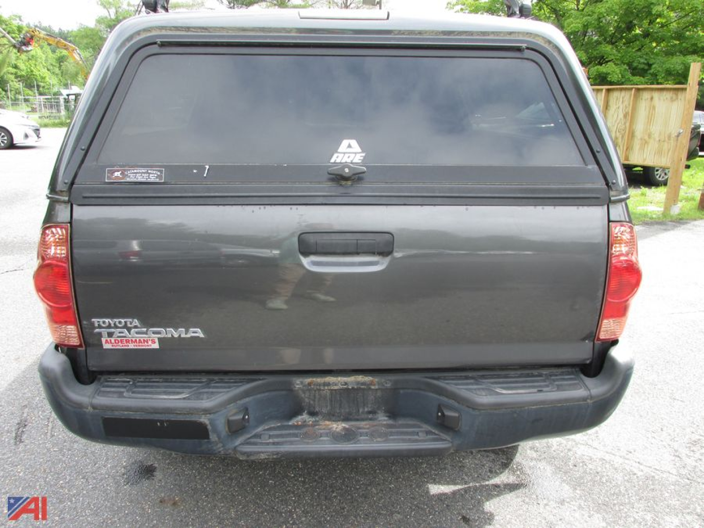 Toyota Tacoma pickup truck tailgate view showing cap and rear bumper with taillights