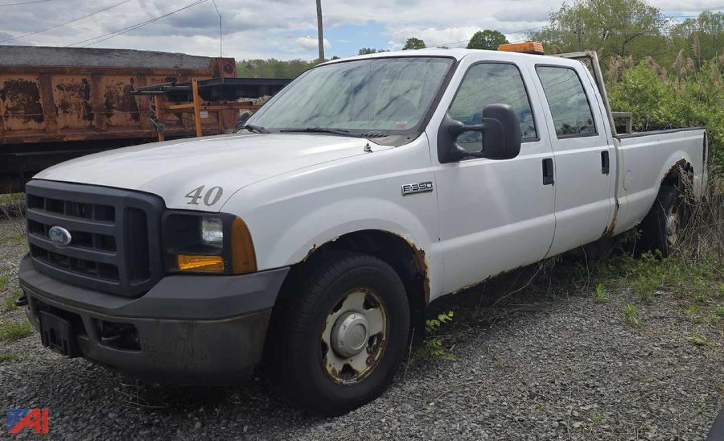 Ford F-350 Super Duty XL crew cab pickup truck in white with rust spots and a long bed, side view showing 4-door cab.
