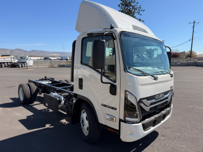 Isuzu NPRXD cab chassis truck with raised sleeper cabin, front grille, and side mirror; image shows cab and chassis sans cargo area.