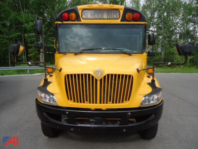 School bus front view showing yellow CE Series bus with grille, headlights, amber lights, and stop sign mirrors.