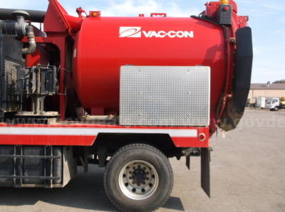 Vac-con vacuum tank on a Freightliner 114SD truck side view showing red cylindrical tank with diamond plate access panel and Vac-Con logo.