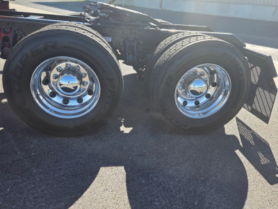 Kenworth T680 wheel chassis showing dual rear dual tires with chrome rims and fender guards.