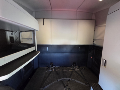 Kenworth T680 truck interior showing sleeper cab and storage compartments.
