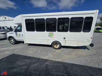 Ford E450 shuttle bus side view showing large windows and wheelchair logo on door area.