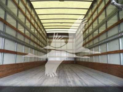 Trailer interior showing empty box truck cargo area with wooden floor and metal side rails.