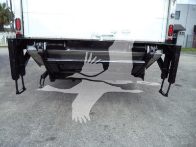 Back of a white box truck with a hydraulic tailgate lift and black mounting arms visible.
