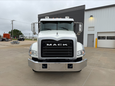 Front view of a white 2016 Mack GU533 roll-off truck showing chrome bumper, black grille with MACK logo, and large side mirrors.