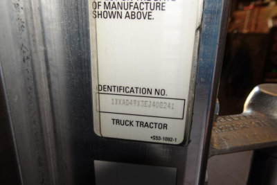 Identification plate on Kenworth T660 with VIN 1XKAD49X3EJ408241 and stock number shown.
