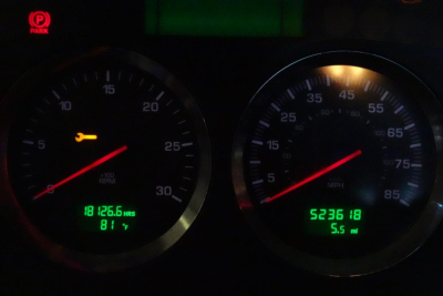 Kenworth T660 instrument cluster showing tachometer and speedometer with digital readouts: left display shows 0-30 dial and green text, right display shows 5.5 miles and 52,365 miles; general dashboard view.