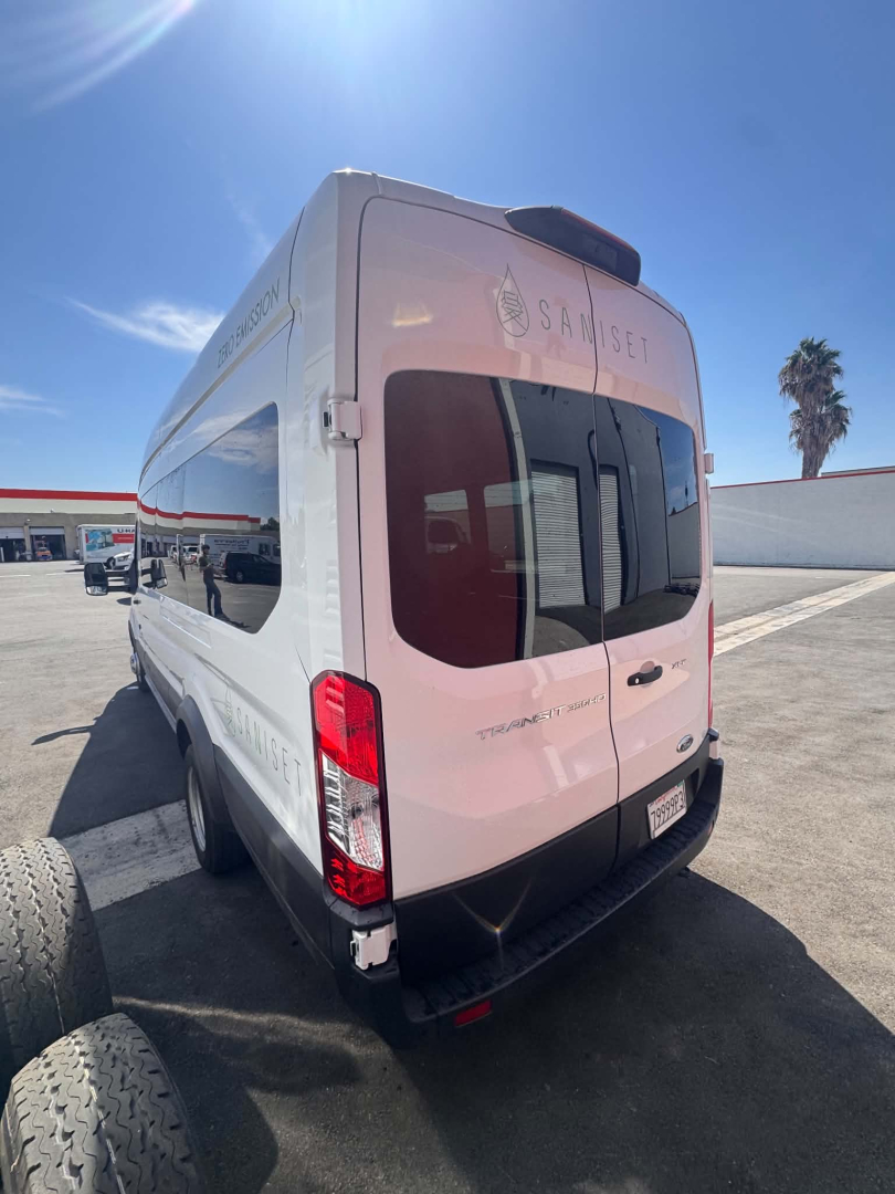 Ford Transit 350 HD XLT rear view showing back doors and Sam Set graphics, white cargo van in an outdoor lot.