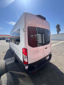 Ford Transit 350 HD XLT rear view showing back doors and Sam Set graphics, white cargo van in an outdoor lot.