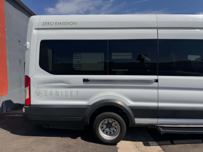 Transit van side view showing 'ZERO EMISSION' and 'SANISET' branding on white Ford Transit 350 HD XLT in-service van.