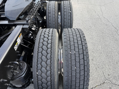 Kenworth T880S chassis with dual rear axles and four tires visible; no visible text readable on components.