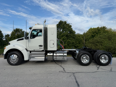 Kenworth T880S conventional sleeper truck side profile showing 6x4 dual rear axles and chrome fuel tanks with steps.