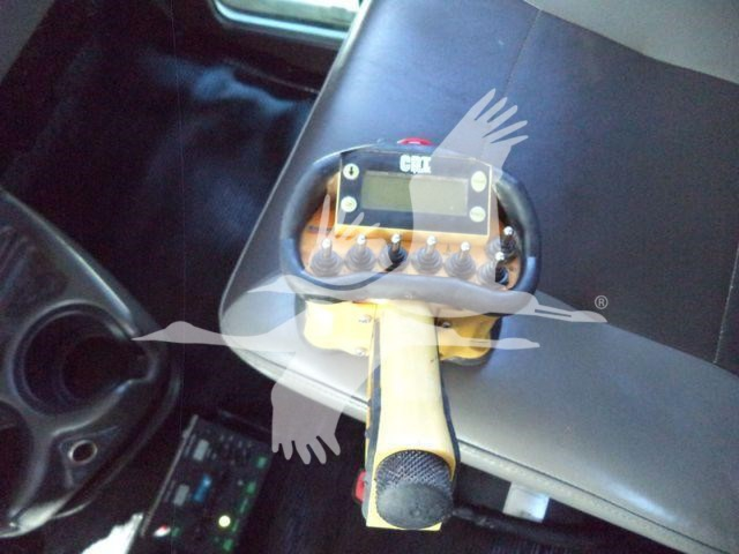 Kennworth T270 interior showing a handheld control unit mounted on the seat and a microphone, with some dashboard area.