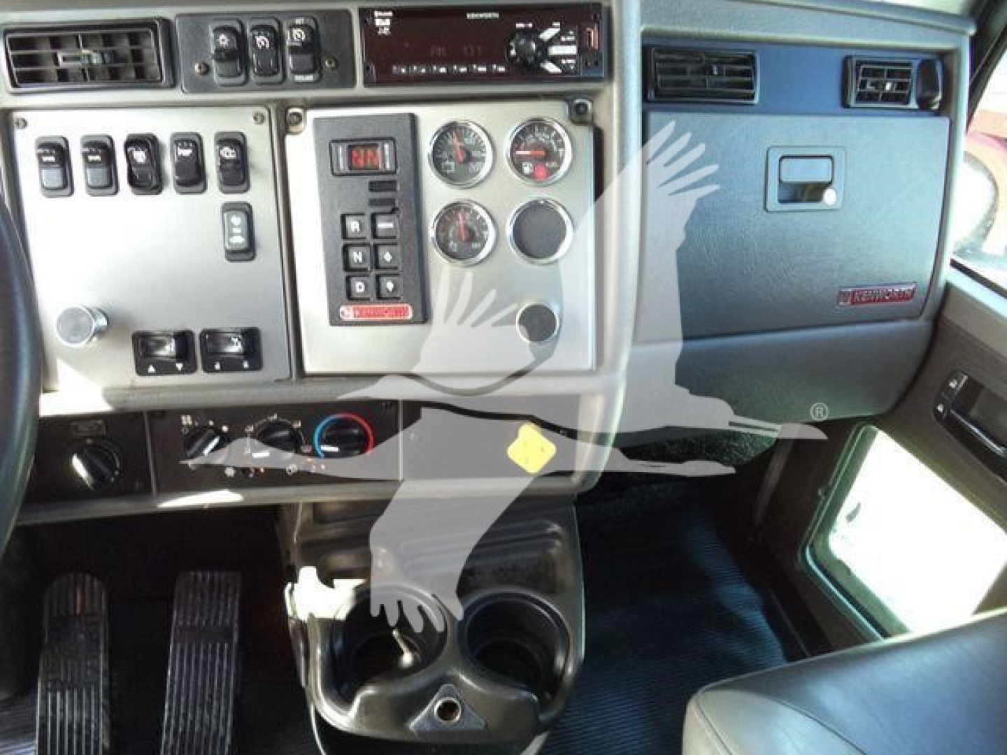 Kenworth T270 truck cab interior dashboard and controls with gauges, switches, and cup holders visible.