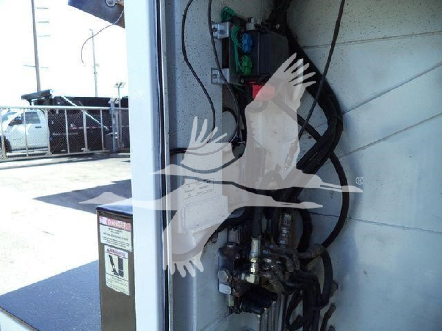 Kenworth T270 service truck engine bay area with hoses and hydraulic components visible; close-up of control valves and wiring.
