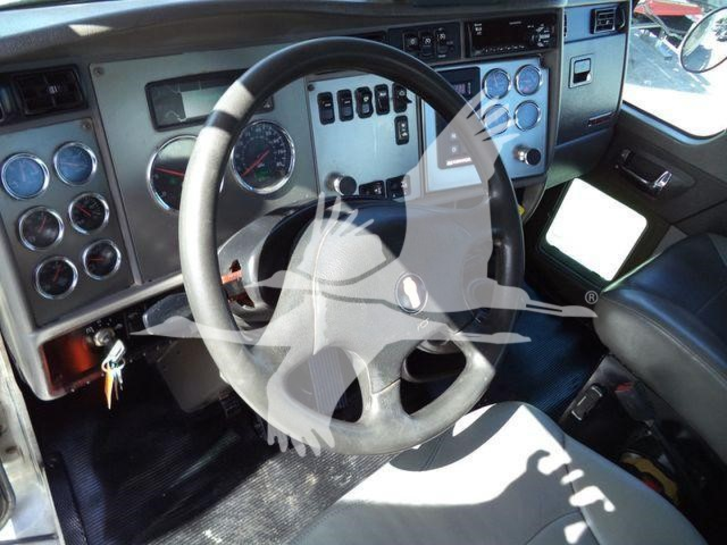 Kenworth T270 cab interior showing steering wheel, instrument cluster, and dashboard switches.