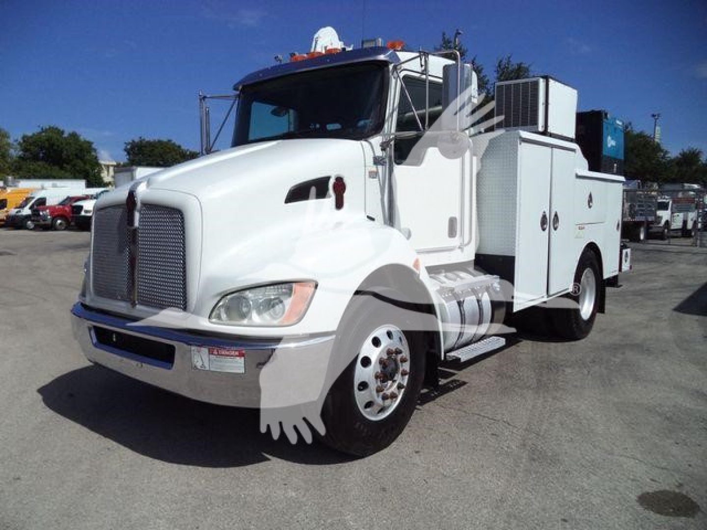 Kenworth T270 service truck in white, side view showing utility compartments, cab with large grille, dual rear wheels, and equipment on bed.