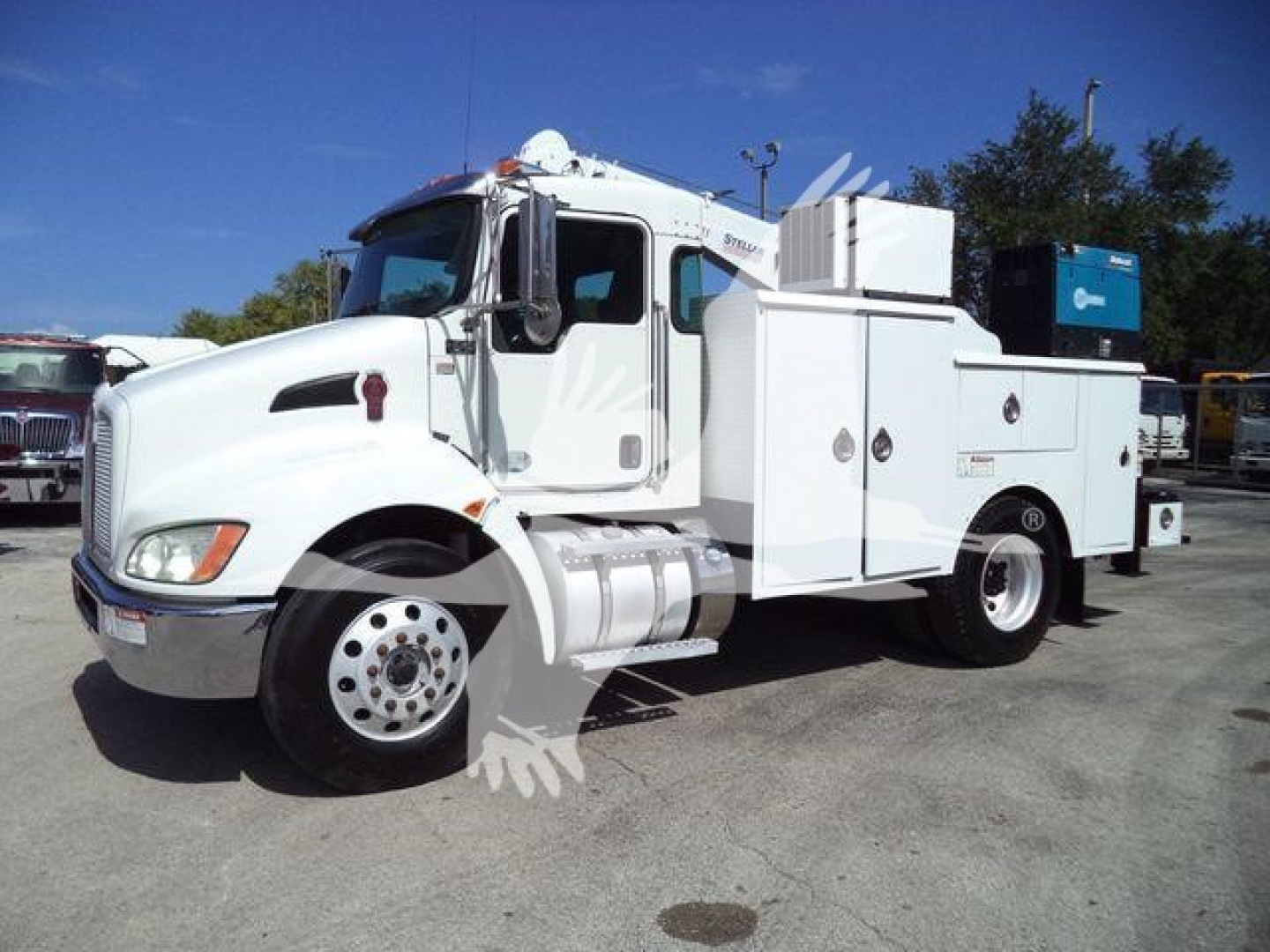 Kenworth T270 utility/service truck in white, side view showing tool compartments, fuel tanks, and a large equipment box in rear.