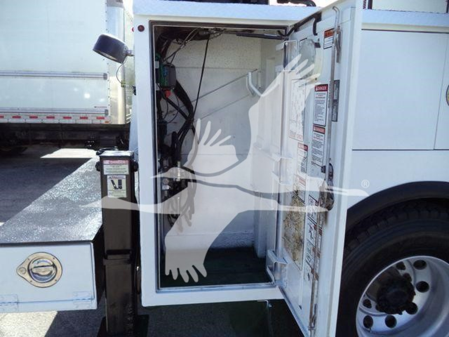 Kenworth T270 service truck rear cargo area open showing wiring and door labels.