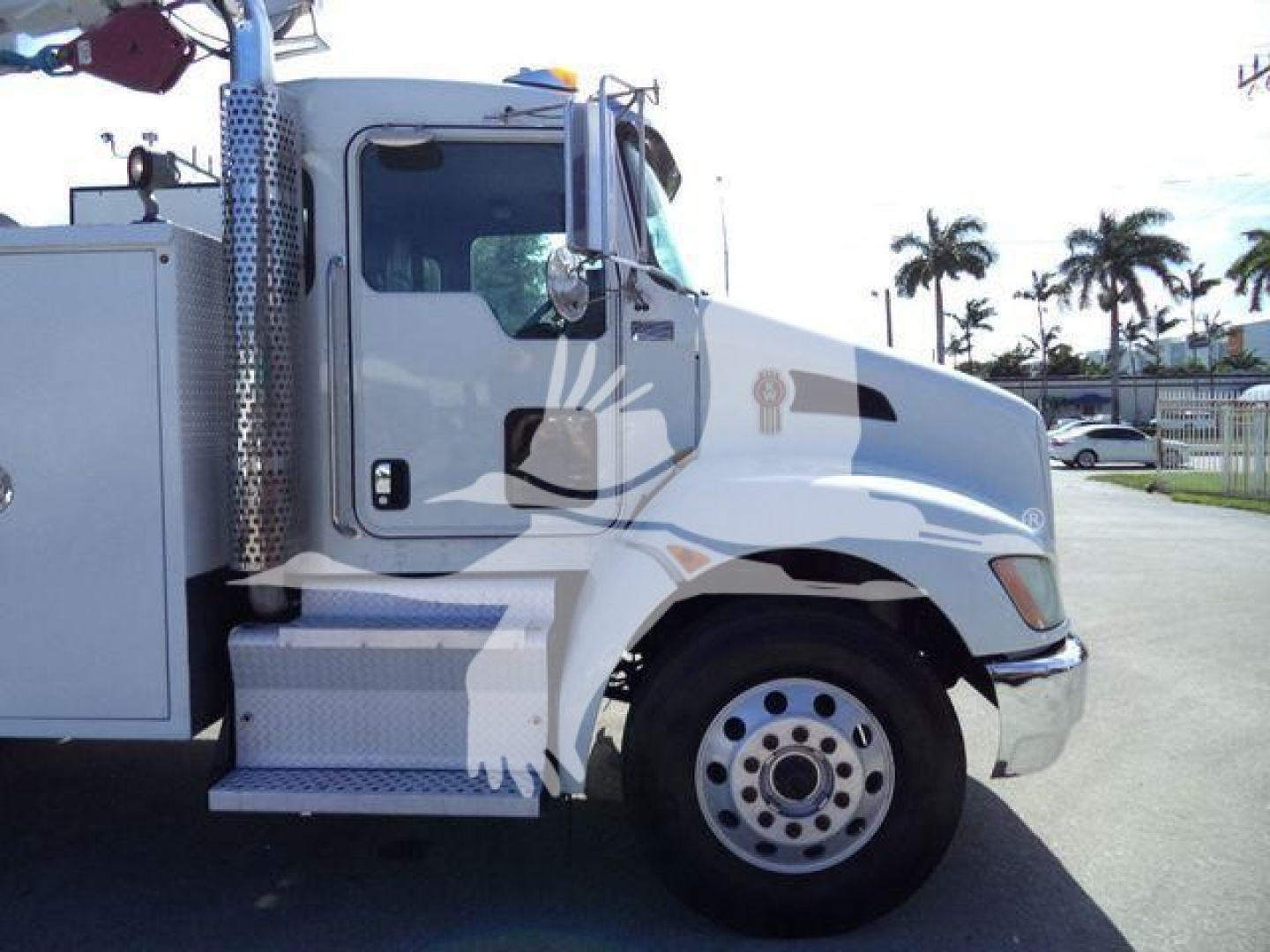 Kenworth T270 service truck side view showing cab and front wheel well with chrome steps and utility compartments.