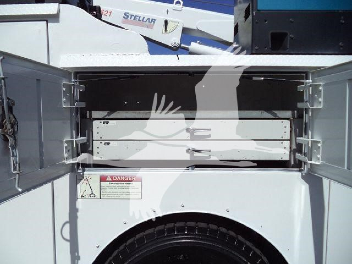 Kenworth T270 service truck bed with open tool/storage compartments and warning label visible.