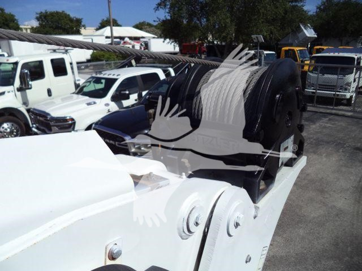 Kenworth T270 service truck with winch spool and crane mount visible; hydraulic hoses and metal framework in view.