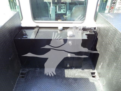 Truck bed area of a 2016 Kenworth T270 service/utility vehicle showing a black battery box and surrounding diamond plate walls.