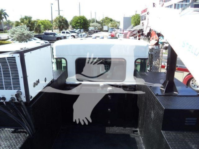 Kenworth T270 cab and bed area with flatbed, showing white cab and black steel frame; no visible text other than VIN/stock in listing.