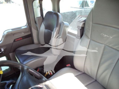 Kenworth T270 interior cab view showing steering wheel and seating; beige/gray upholstery with Rea?egy branding on seat; dashboard and window visible.