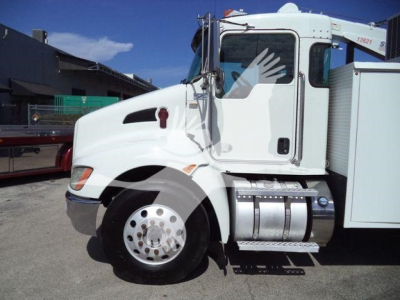 Kenworth T270 service truck side view showing white cab and chrome fuel tanks with steps.