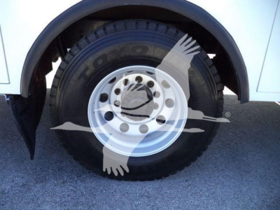 Kenworth T270 wheel and tire close-up showing Toyo tire on white steel rim, front fender and wheel well visible.