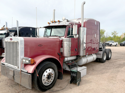 Peterbilt 379 UltraCab conventional sleeper truck with extended hood, maroon color, chrome fuel tanks and exhaust stacks.