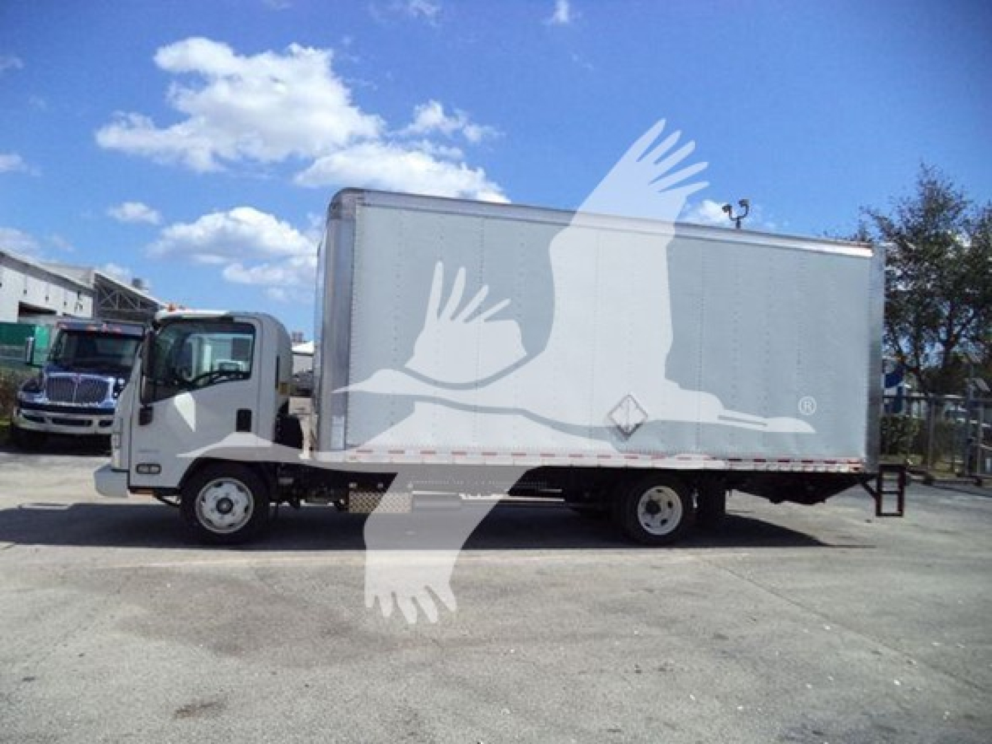 Isuzu NPR box truck in side profile showing cargo box, cab, and wheels.