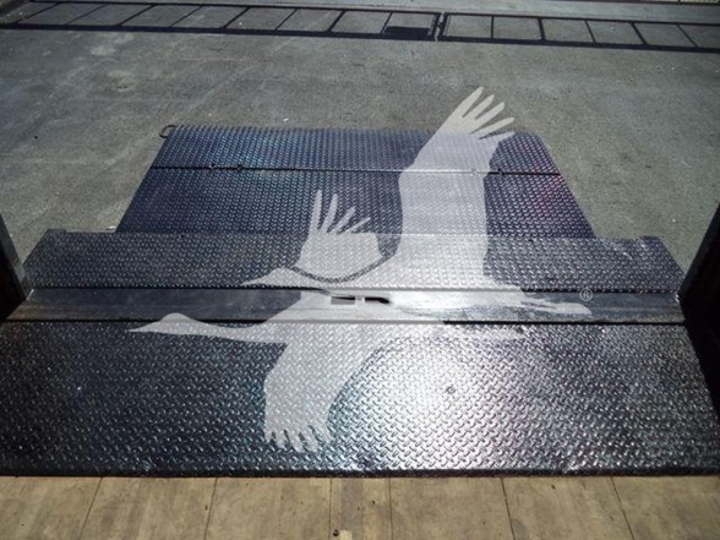 Isuzu NPR box truck bed floor panels in view with diamond plate texture.