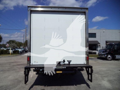 Isuzu NPR box truck rear view showing clean white cargo doors and bumper with reflective labels.